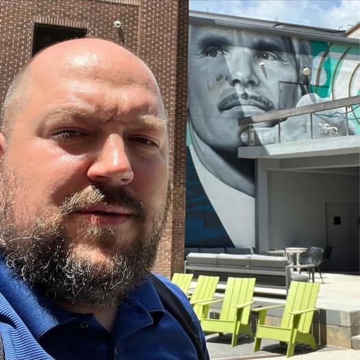 Dave Ostrowski at the Turner Broadcasting campus in Atlanta, in front of a Ted Turner mural
